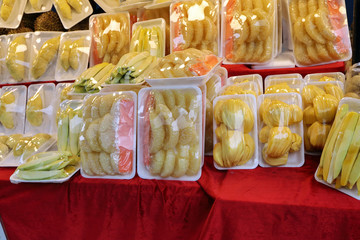 Fresh cut fruit wrapped in plastic selling at street market pomelo mango durian mango jackfruit