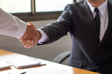 Close up view of business partnership handshake concept.Photo of two businessman handshaking process.businessman shaking hands in office. Collaborative teamwork
