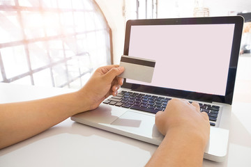 Credit card use to shopping by Business women with telephone and lab top computer.