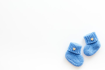 Booties for newborn boy on white background top view mock up