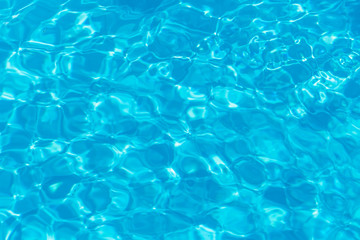 Fototapeta na wymiar Blue pool water with sun reflections