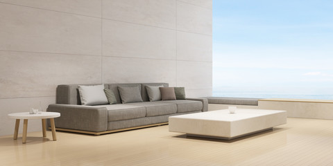 Perspective of modern luxury living room with grey sofa and side table on sea view background, Minimal,travertine wall. - 3D rendering.