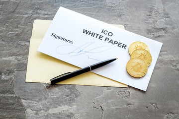 White paper ICO, coins, pen on gray textured background