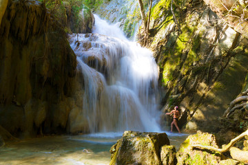 Woman with bikini black and waterfall at Erawan Waterfall