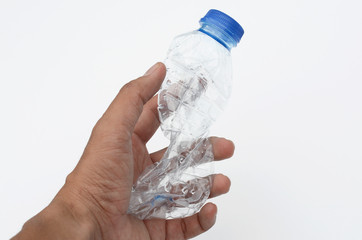 water bottles crushed and crumpled against white isolated background. Men hand hold and crushing plastic bottle.