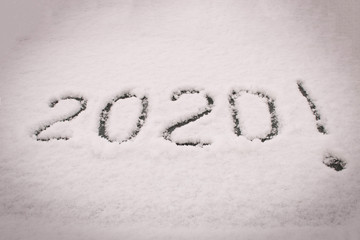 The inscription 2020 on the snow. The inscription on the glass of the car. The concept of a New year.