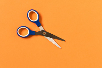 Scissors on yellow background. Colored baby scissors.