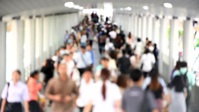 A Lots of people in public skywalk Chong Nonsi for transit between sky train in bangkok downtown square in business zone in evening rush hour,Out of focus
