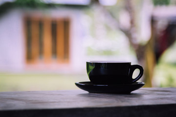 Coffee cup on cement table with nature background