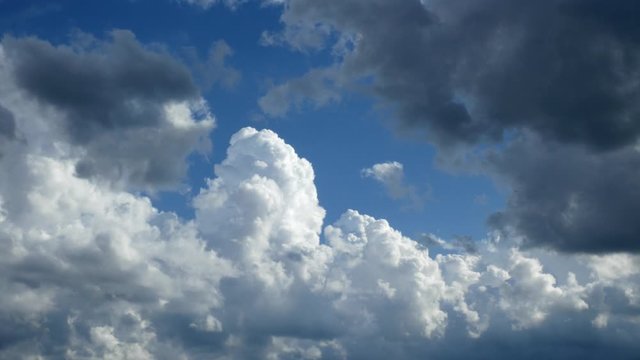 Storm clouds brewing in time-lapse clip. Beautiful blue sky with cumulus congestus clouds on a mostly sunny day.