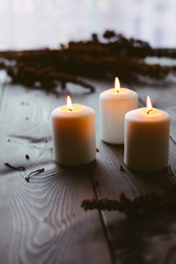 White Candles Burning On Wooden Tabletop