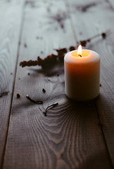 Obraz na płótnie Canvas White Candle Burning On Wooden Tabletop