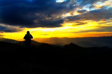 Sunset with black cloud and traveler