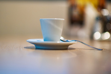 A cup of coffee on a table in a cafe.