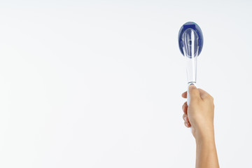 Hand holding new sponge brush with plastic handle