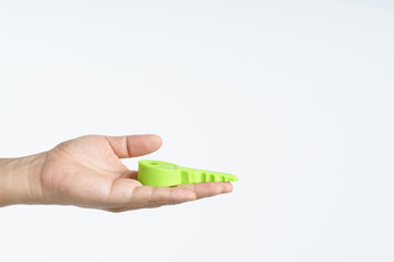 Hand holding big plastic or rubber key for door stop