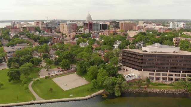 4k aerial footage panning left to right of Madsion Wisconsin capital building and surrounding buildings in downtown