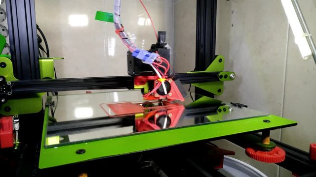 green and black 3d printer printing pla