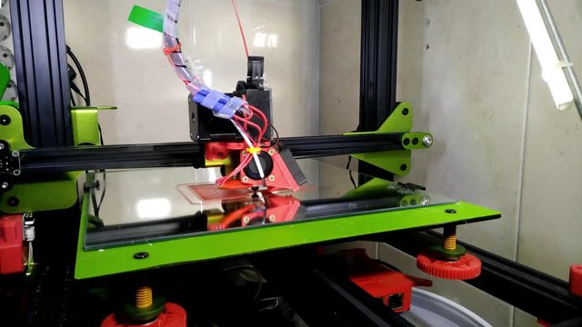 green and black 3d printer printing pla
