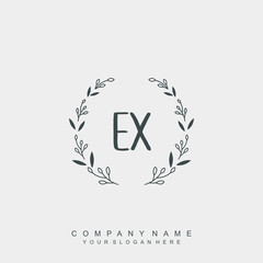 letter EX surrounded by beautiful and elegant flowers and leaves. Wedding monogram logo template.