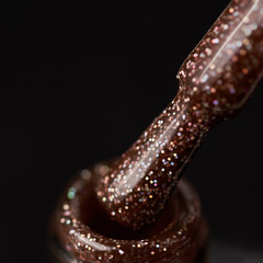 nail polish brush at the neck of the bottle close-up