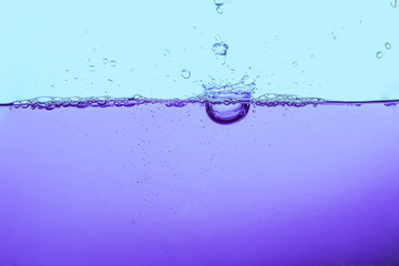 Water splash or water wave with bubbles of air on the background.