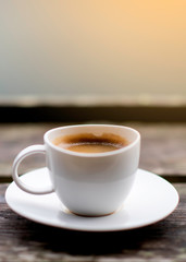 cup of coffee on wooden table