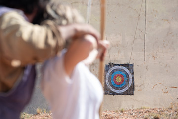 man teaching to shoot with bo