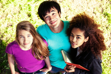 cute group of teenages in green park at summer with books huggings, diversity nations real students lifestyle