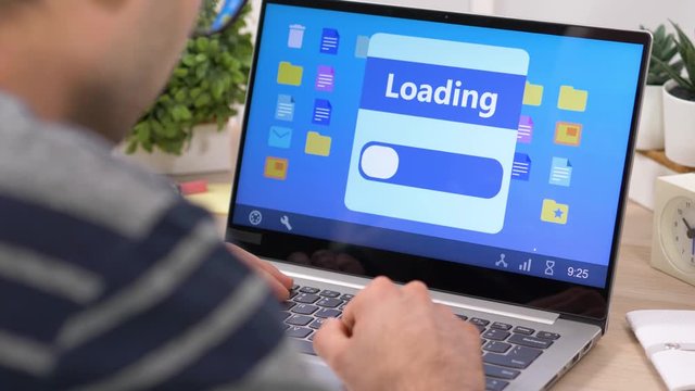 Waiting for the loading screen to end on a laptop computer