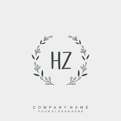 letter HZ surrounded by beautiful and elegant flowers and leaves. Wedding monogram logo template. Fashion Logo template Vectors,
