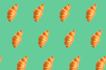 Fresh croissants seamless pattern on green background