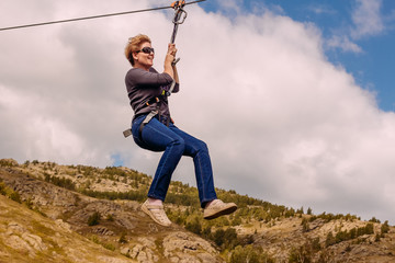 Smiling woman rides on a bungee