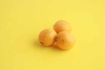 delicious yellow medlar fruit with colorful background
