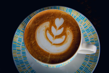 Cup of hot latte coffe on table.