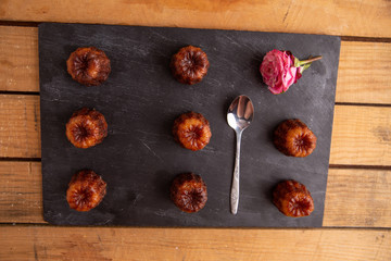 French pastry Caneles de bordeaux rum and vanilla flavor thick caramelized crust on black slate...