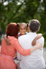 Dark-eyed African-American girl meeting her adoptive parents