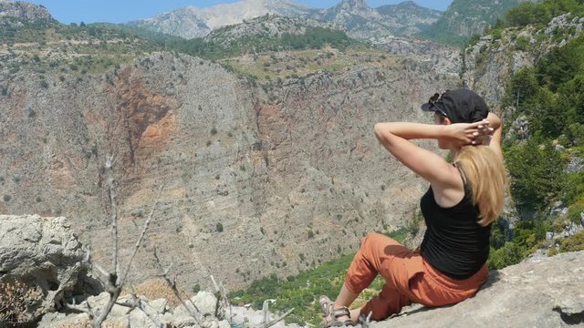Woman traveller enjoying beautiful view of The Butterfly Valley from the top of the mountain