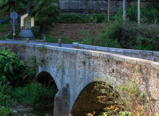 Castiglione Olona - Italy, medieval stone bridge crosses the Olona river