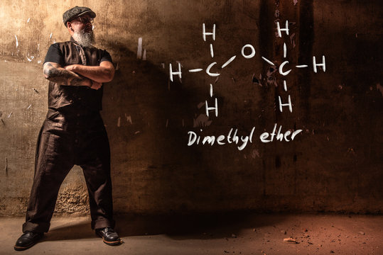 Bearded old man presenting handdrawn chemical formula of Dimethyl ether methoxymethane DME