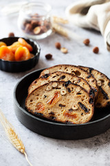 Slices of rye bread with hazelnuts and dried fruit like apricots, raisins and plums
