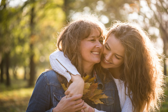 Daughter hugging her mother - autumn season