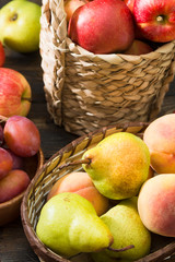 Fruit in baskets on a wooden table. Harvest