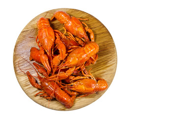 Boiled crayfish on wooden cutting board isolated on white background