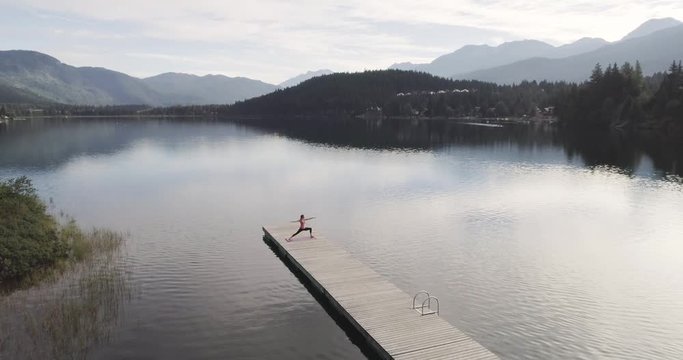 Woman Doing Yoga At A Lake In The Mountains 