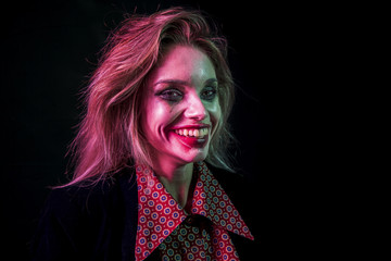 Woman dressed as joker smiling with her teeth
