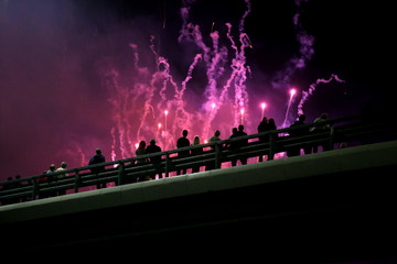 Silhouettes of people watching fireworks