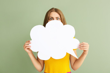 Surprised young woman with speech bubble on color background