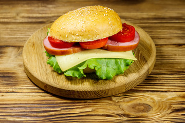 Fresh delicious homemade cheeseburger on wooden table