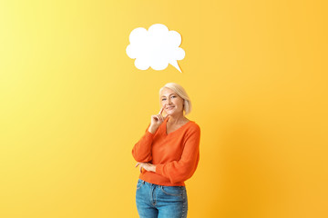 Stylish mature woman with blank speech bubble on color background